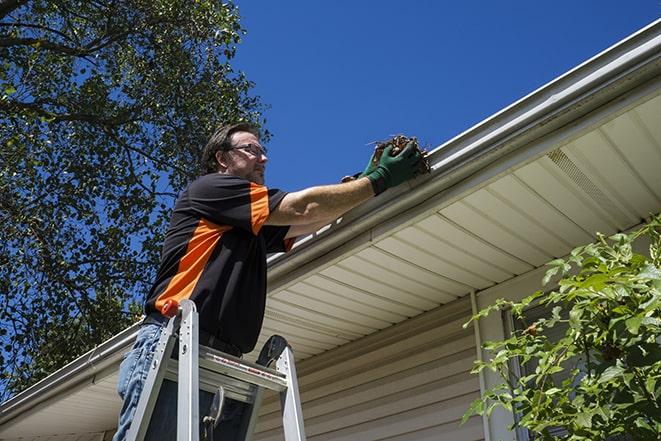 technician replacing a rusted gutter in Arlington